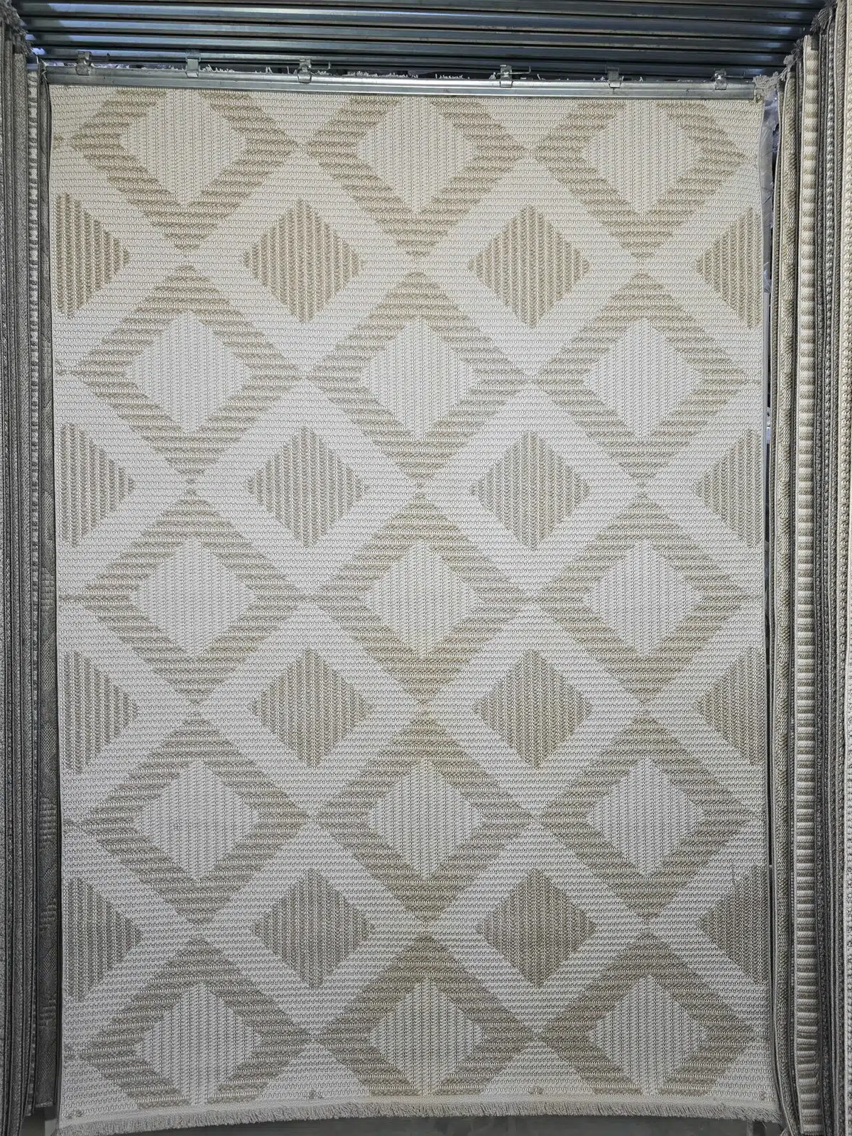 Full view of Comet rug hanging in showroom