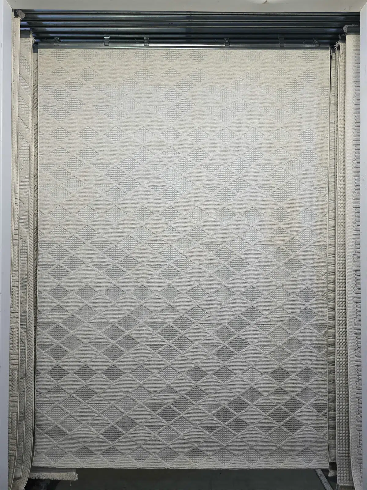 Elegant cream Mars carpet with repeating diamond texture, full frontal view