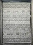 Hanging Nebulon rug featuring grey tribal and stripe patterns