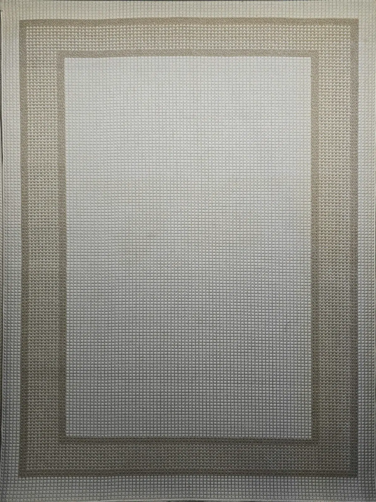 Full image of Orbit rug with a subtle textured center and modern beige border