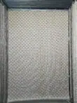 Full view of Helios checkerboard carpet hanging in display area