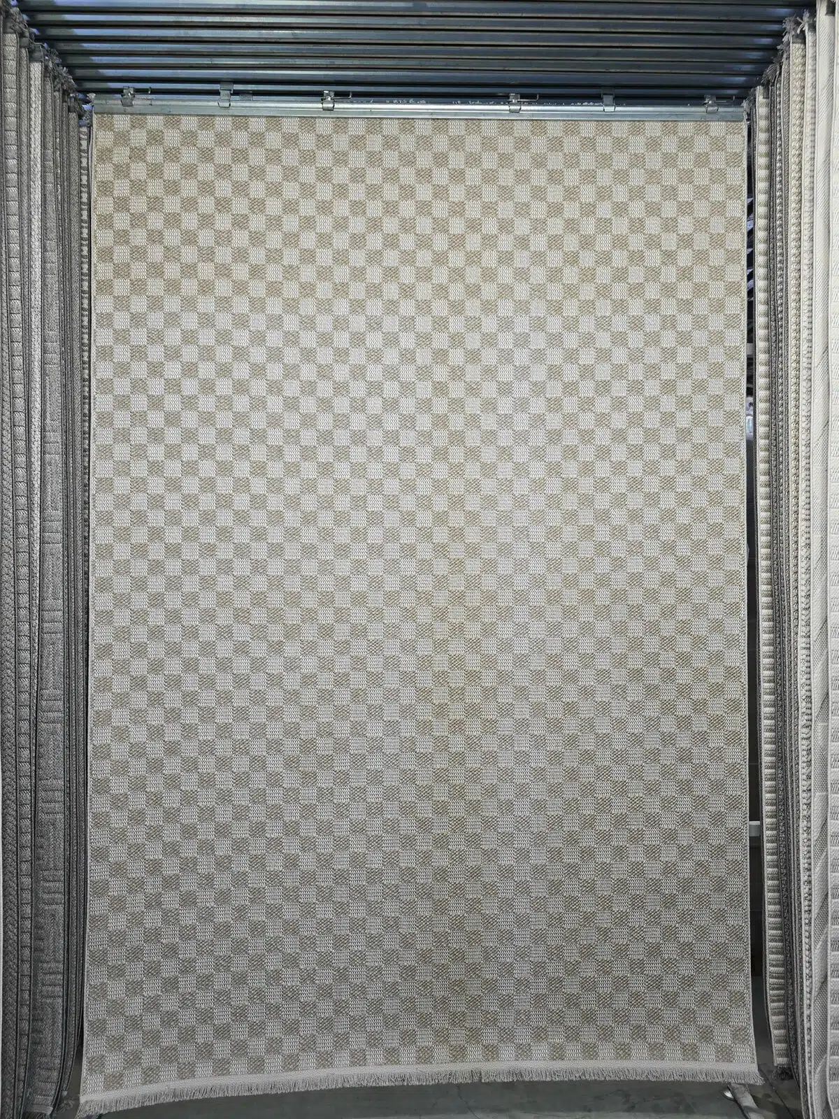 Full view of Helios checkerboard carpet hanging in display area