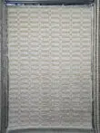 Beige and cream checkered rug with geometric pattern – Umbra design.