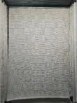 Full view of the Vortex rug showing geometric pattern in ivory and beige