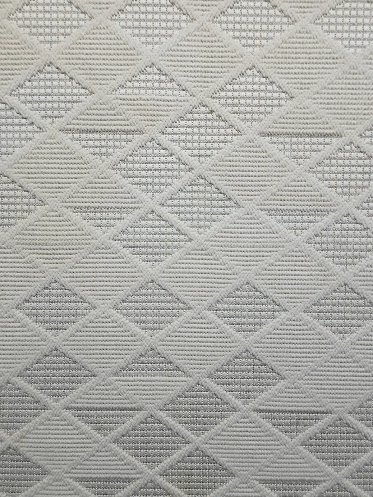 Mars carpet pattern showcasing textured diamonds in ivory and grey shades