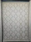 Full hanging view of the Nocturne beige rug with diamond patterns