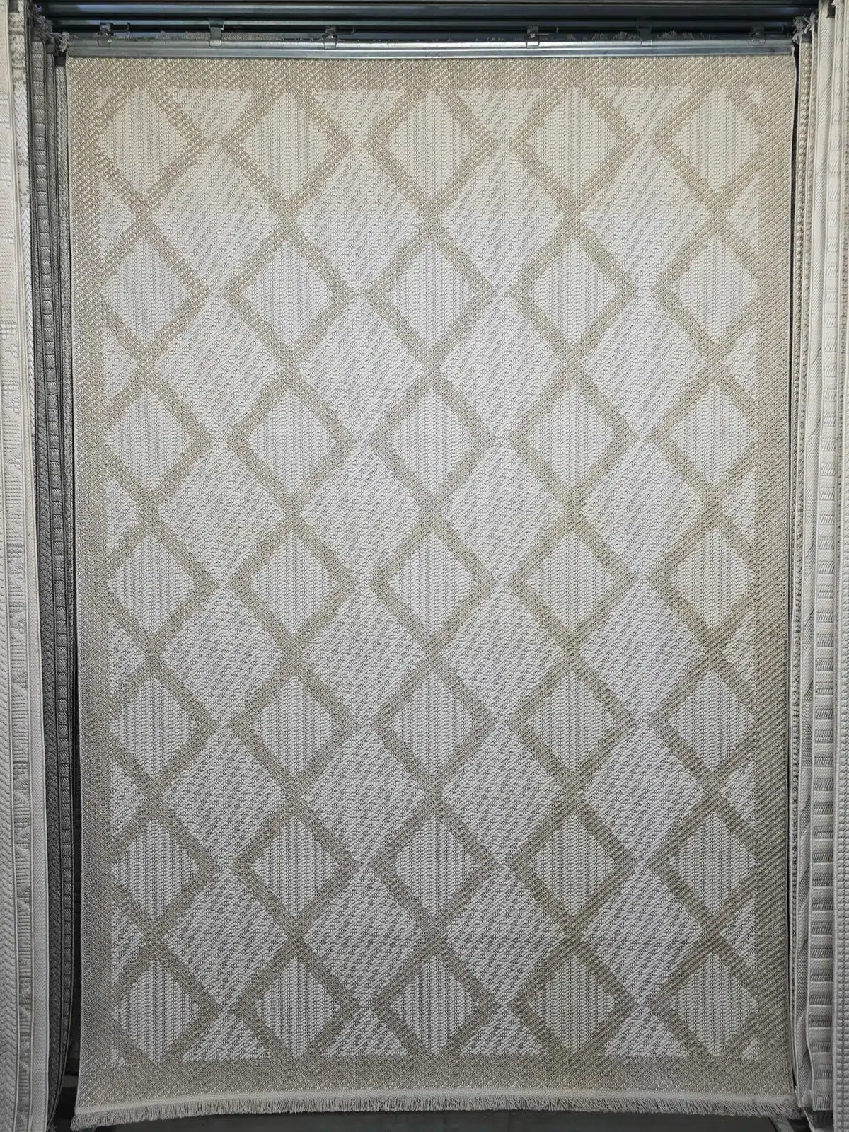 Full hanging view of the Nocturne beige rug with diamond patterns