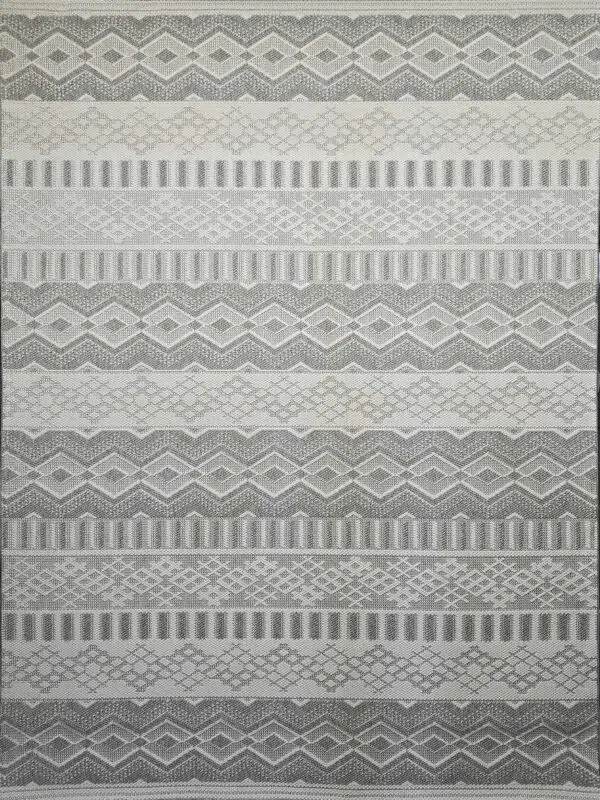 Detailed shot of Nebulon rug’s grey and cream diamonds