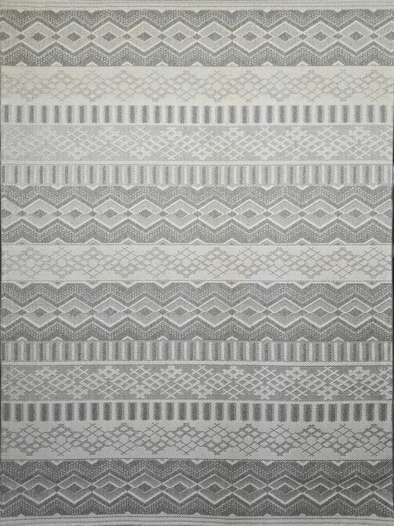 Detailed shot of Nebulon rug’s grey and cream diamonds