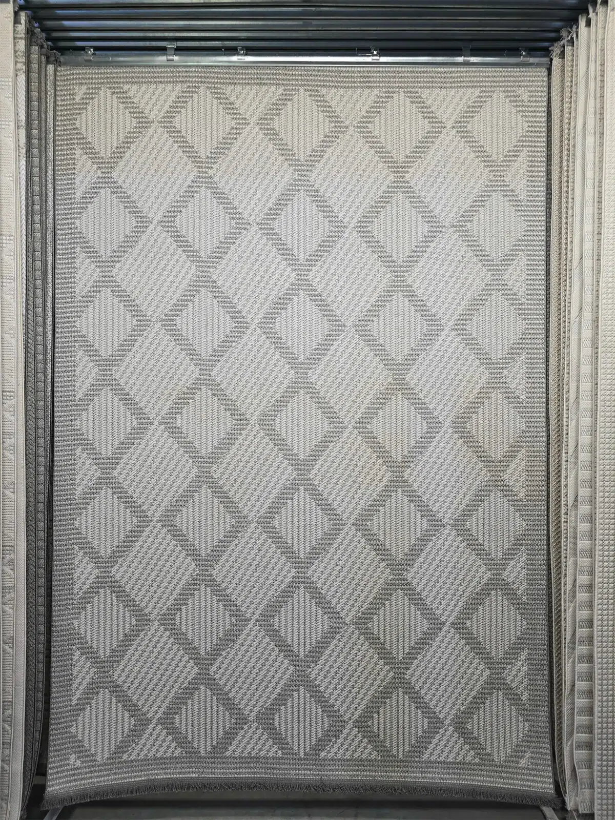 Full hanging view of Zephyr rug showcasing its diamond-shaped woven texture