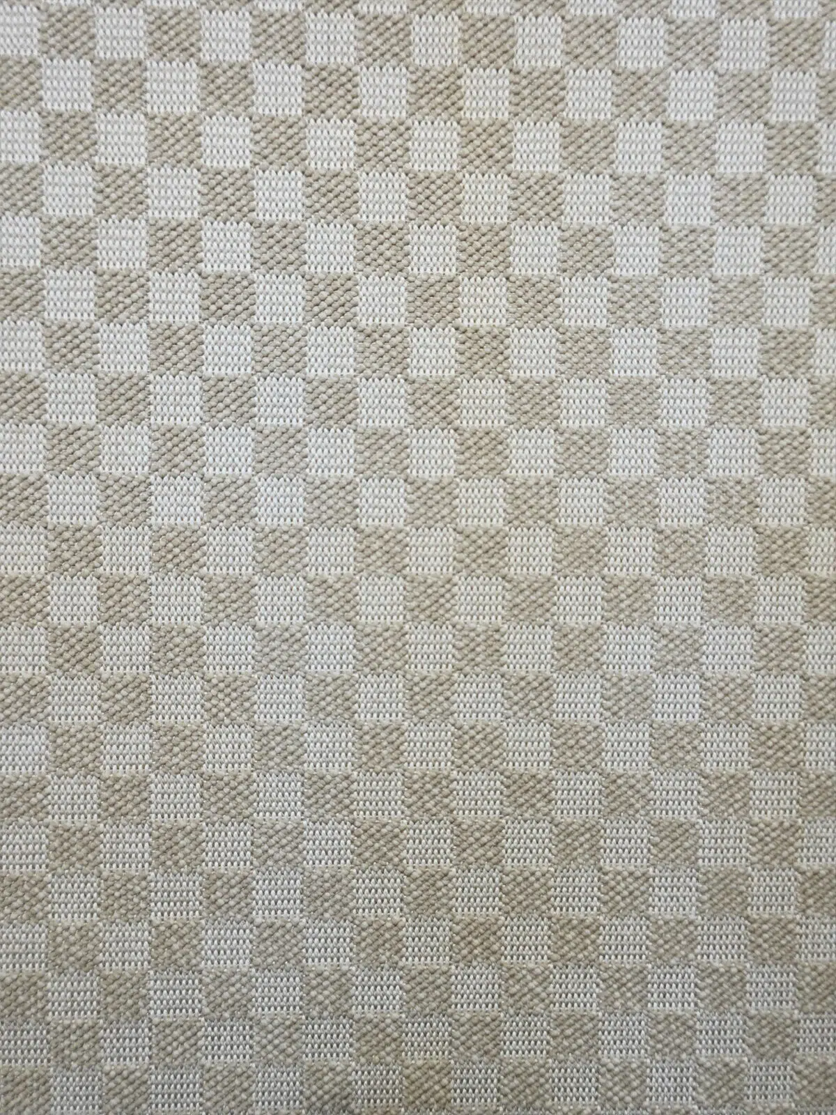 Closeup mid-area of the Helios rug highlighting check pattern and weave