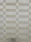 Close-up of Umbra rug’s texture and weave pattern in beige.