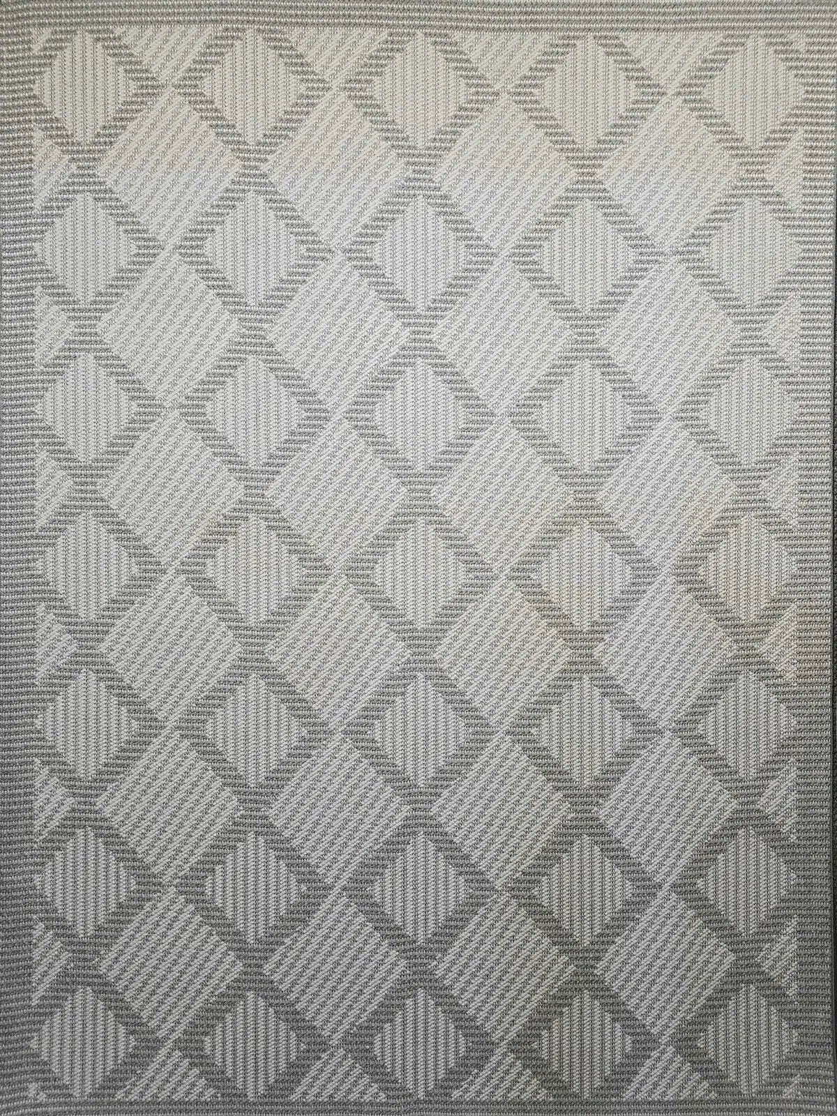 Complete flat layout of Zephyr rug with textured diamond grid design