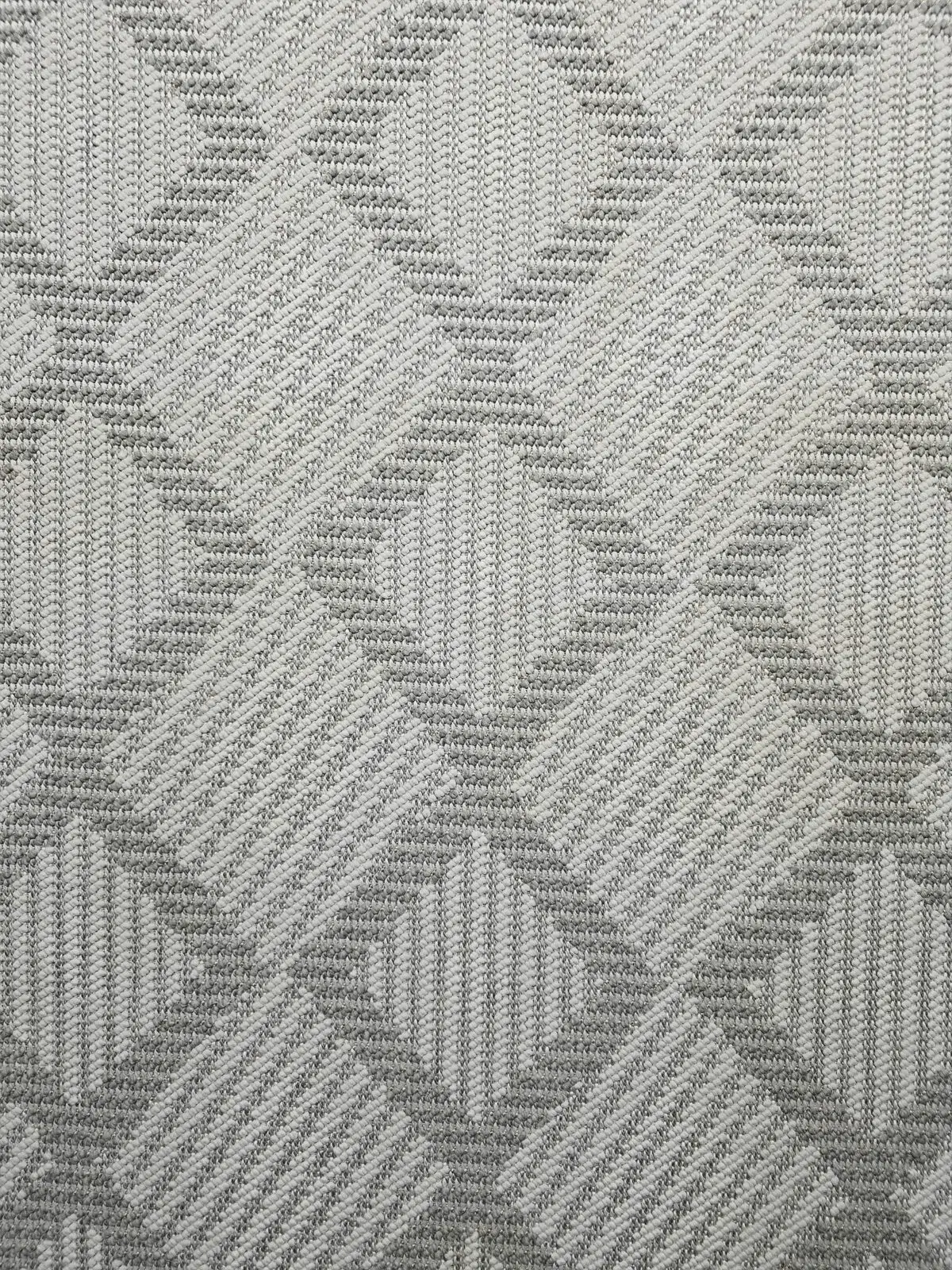 Zoomed-in image of Zephyr rug’s diamond pattern in neutral tones
