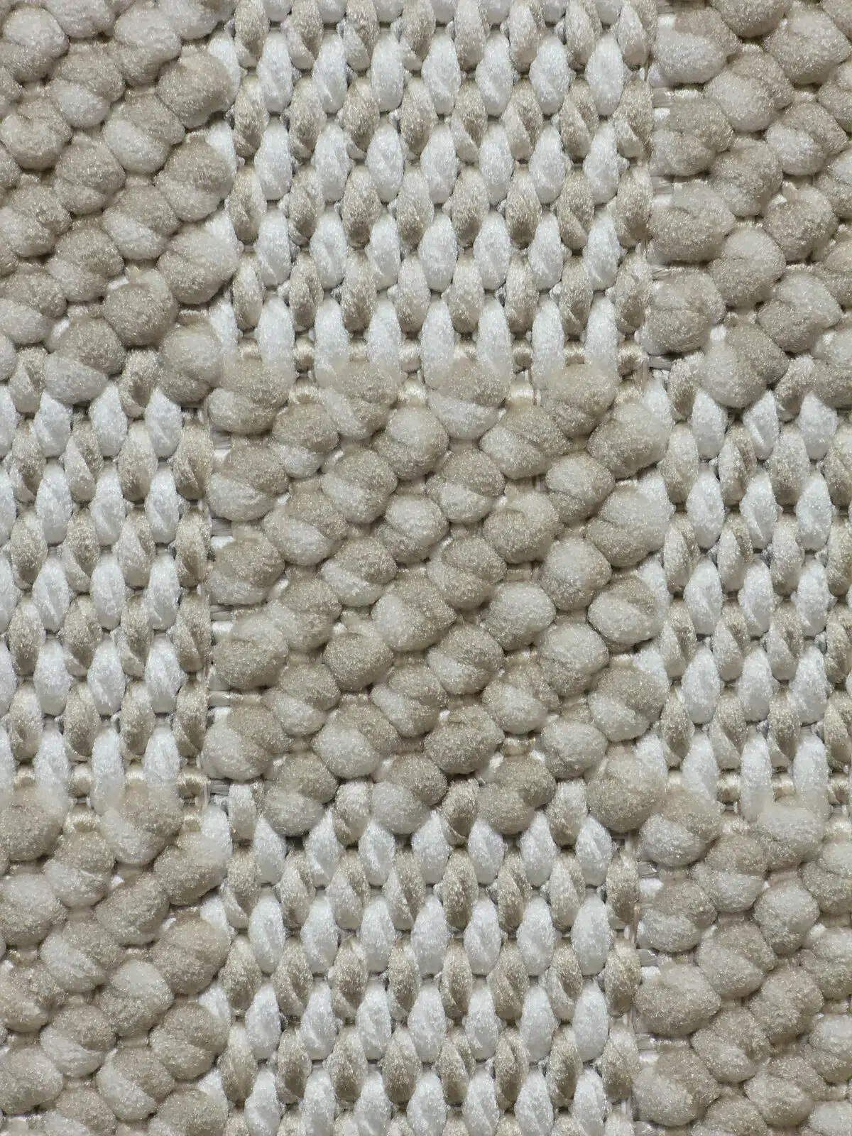 High-detail shot of the checker pattern and yarns on Helios rug