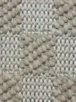 Macro image of Umbra rug knots in beige and cream tones.