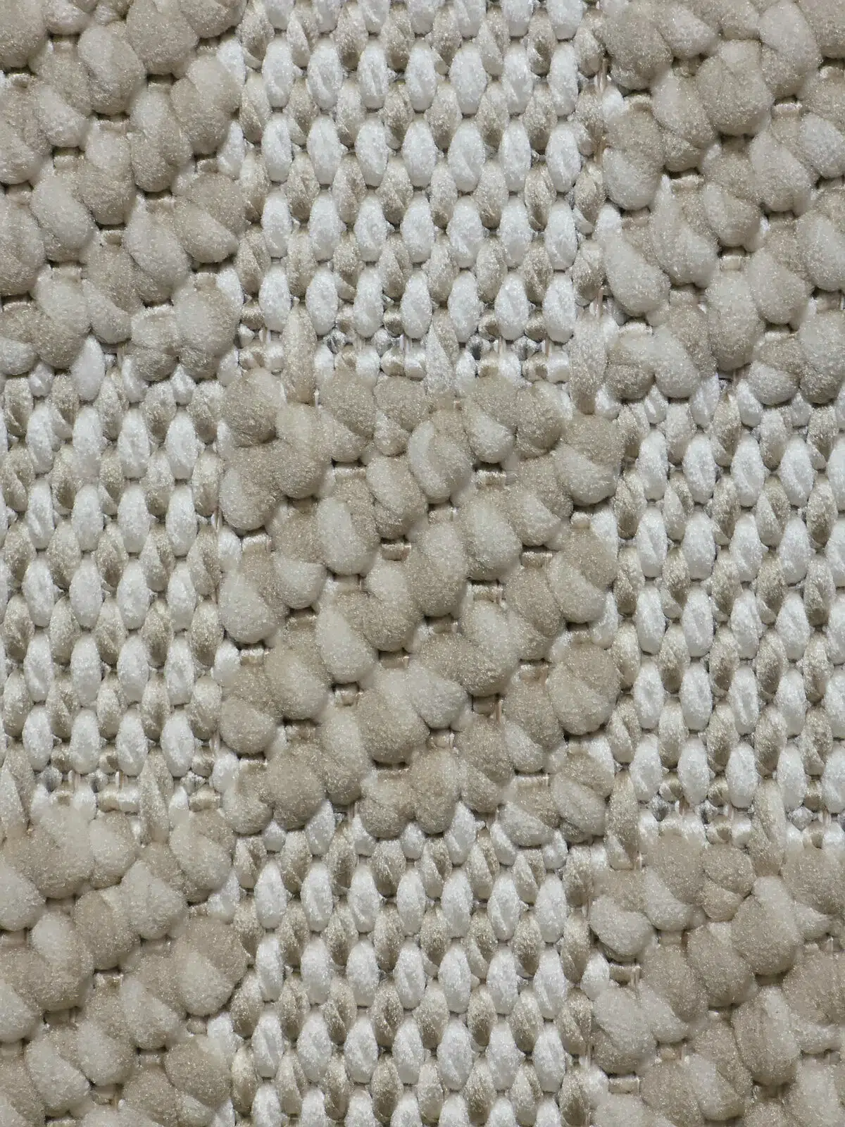 Macro image of Umbra rug knots in beige and cream tones.