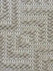 Macro shot of looped yarn in beige and ivory on Oberon rug