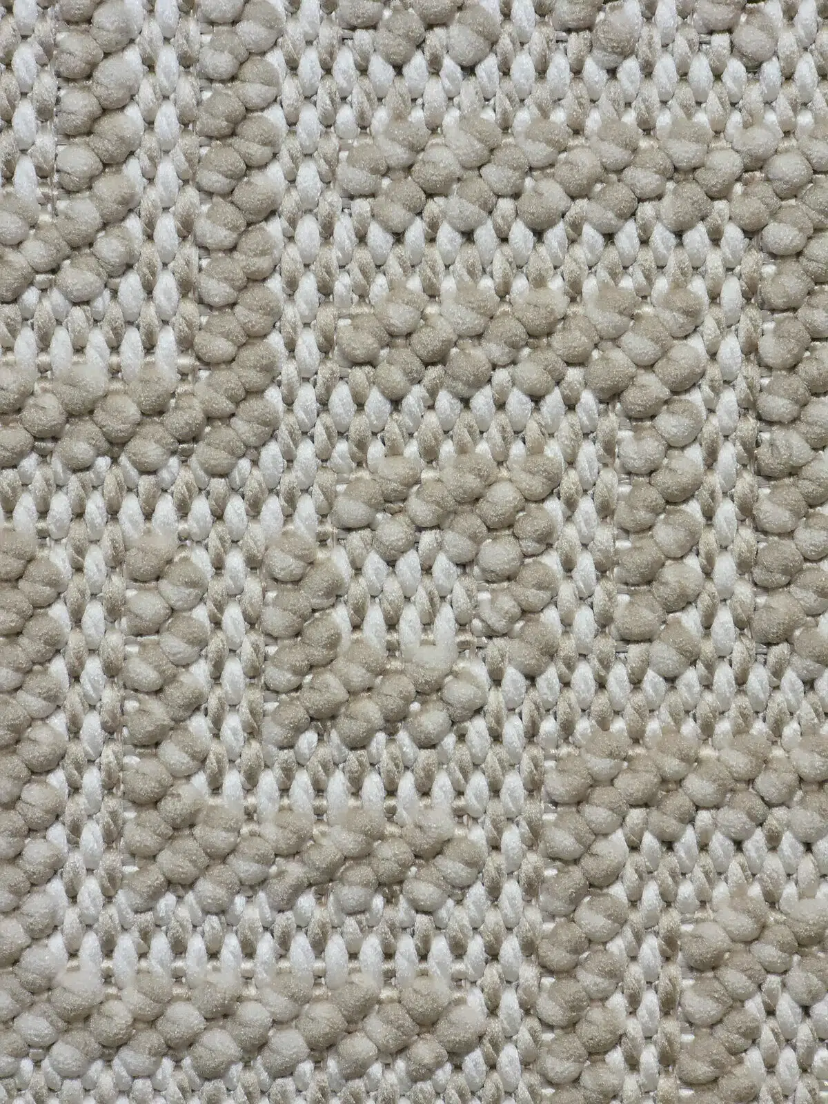 Macro shot of looped yarn in beige and ivory on Oberon rug