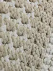 Orbit rug close-up showing beige textured corner of the outer frame