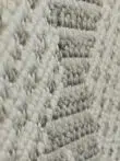 Side diagonal close-up of Zephyr rug showing raised loops and shine