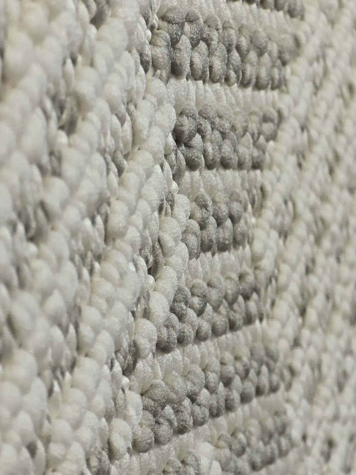 Side diagonal close-up of Zephyr rug showing raised loops and shine