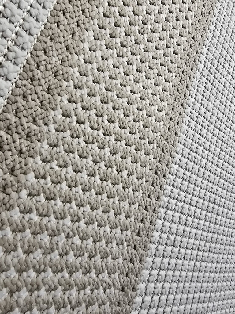 Diagonal texture of Orbit carpet showing looped yarn and detailed edge