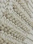 Beige woven rug surface texture from tilted view