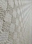 Angled closeup of Helios rug highlighting light beige fiber detailing