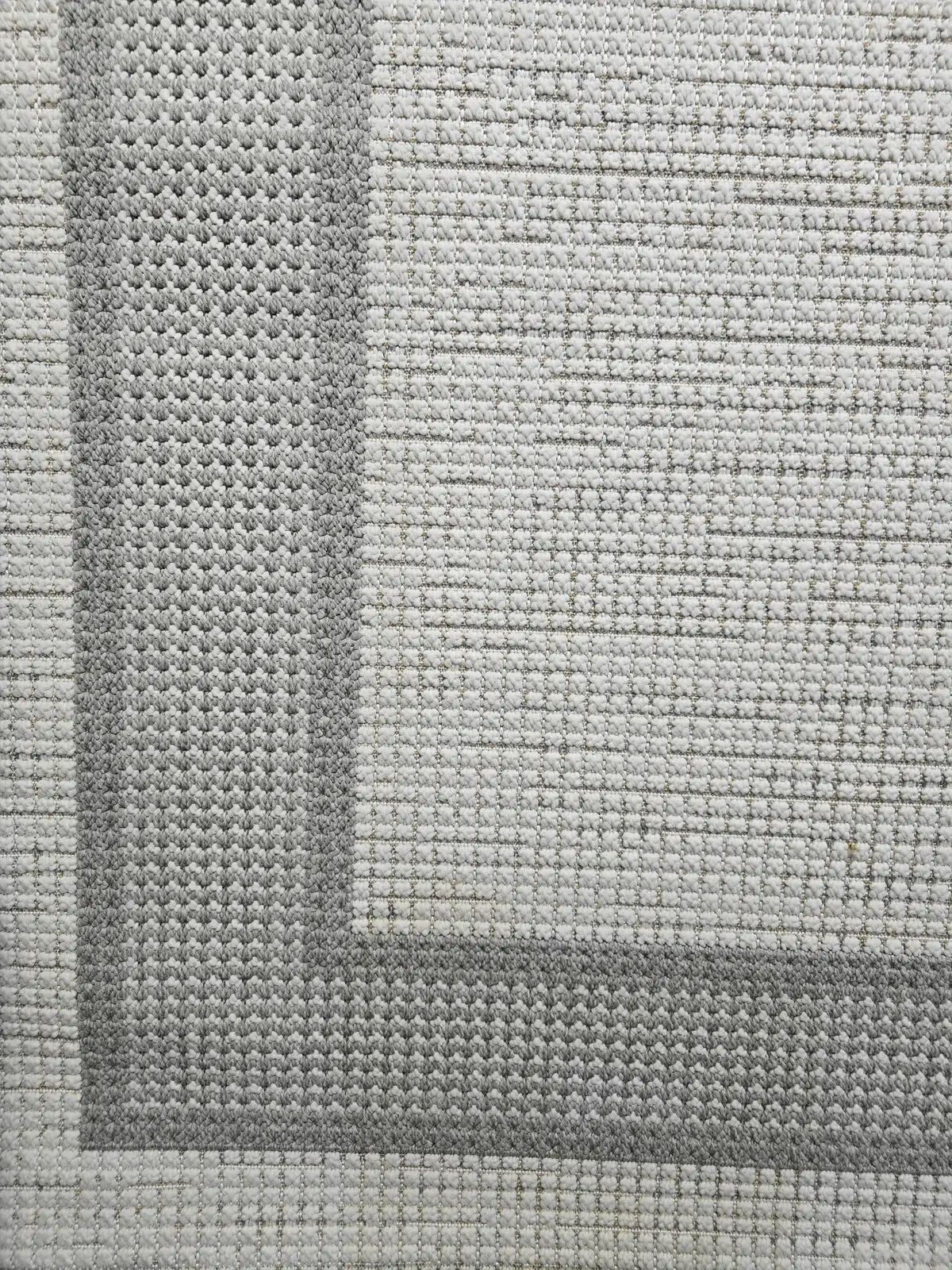 Juno carpet close-up of corner with sharp geometric border design