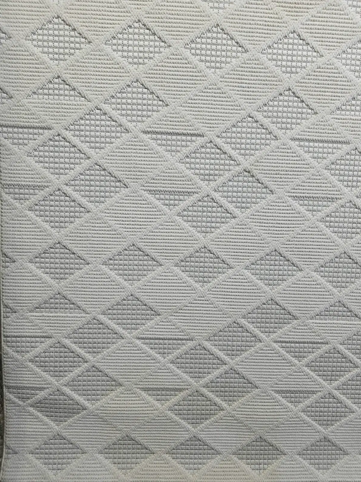 Cream-colored Mars carpet photographed diagonally to show repeating diamond flow