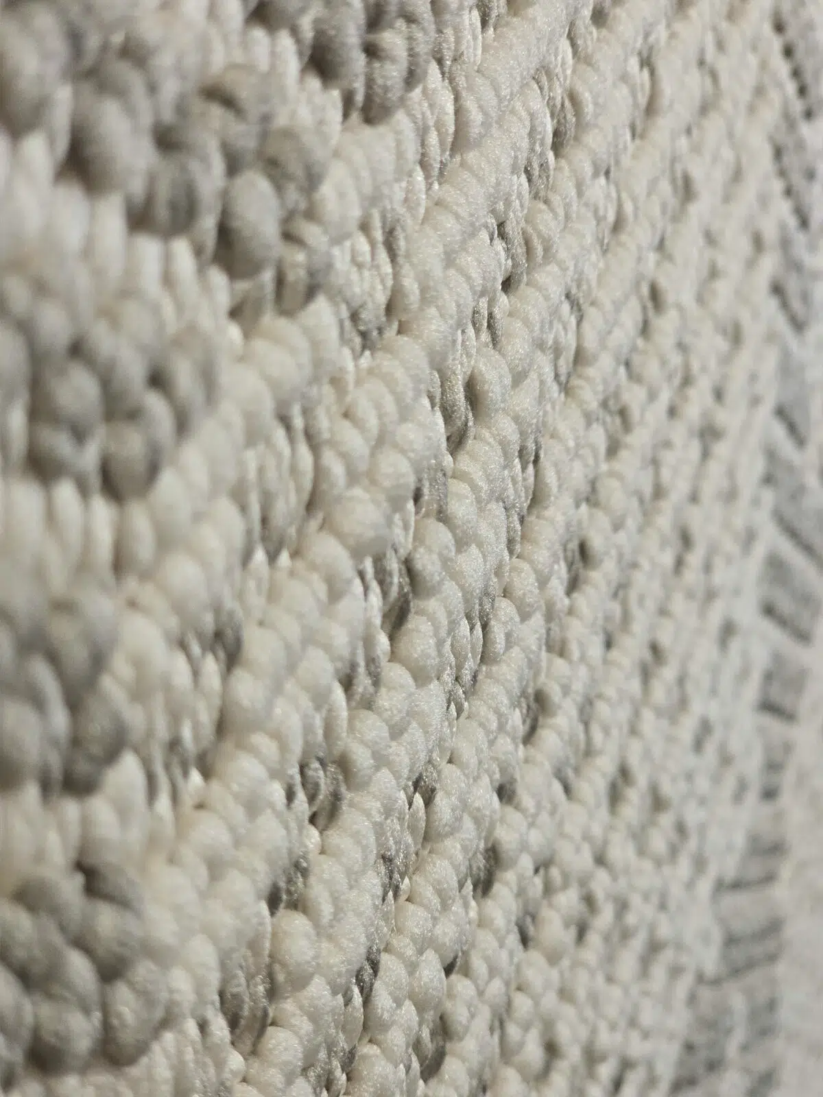 Close side view of Zephyr rug fibers in white and grey blend