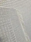 Rear of Orbit rug showing tight weave and cream fringes