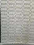 Bottom view of Umbra rug’s pattern with visible fringe.