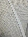 Rear view of Juno rug showing woven backing and stitched edge