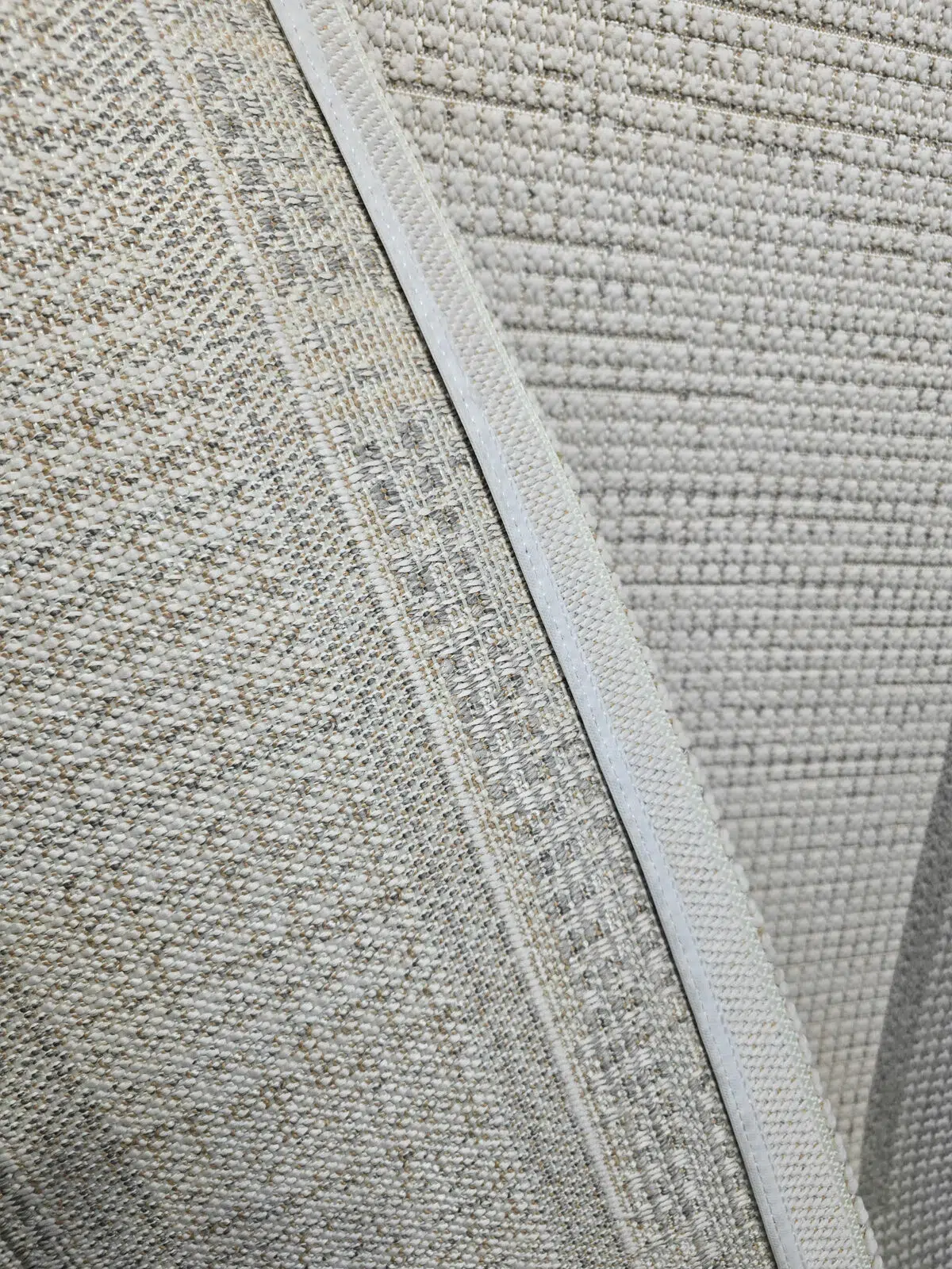 Rear view of Juno rug showing woven backing and stitched edge