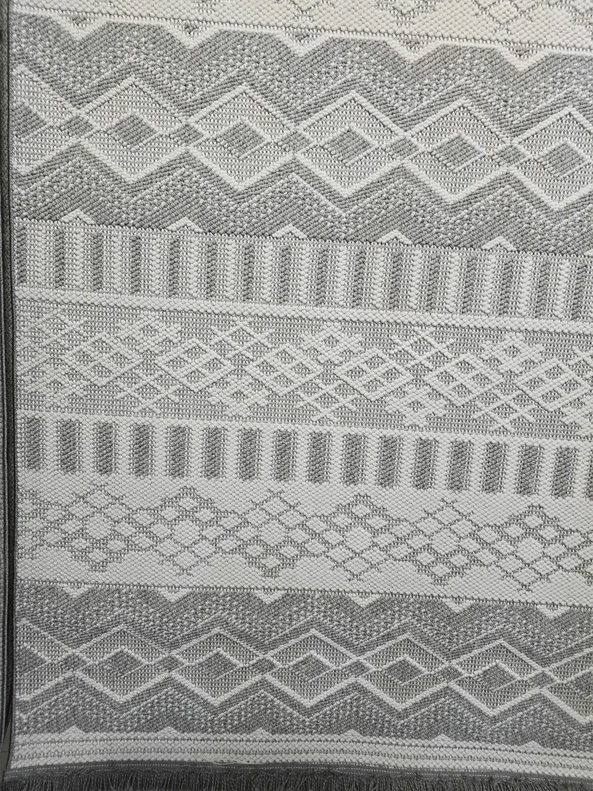 Lower section with fringe and repeating pattern