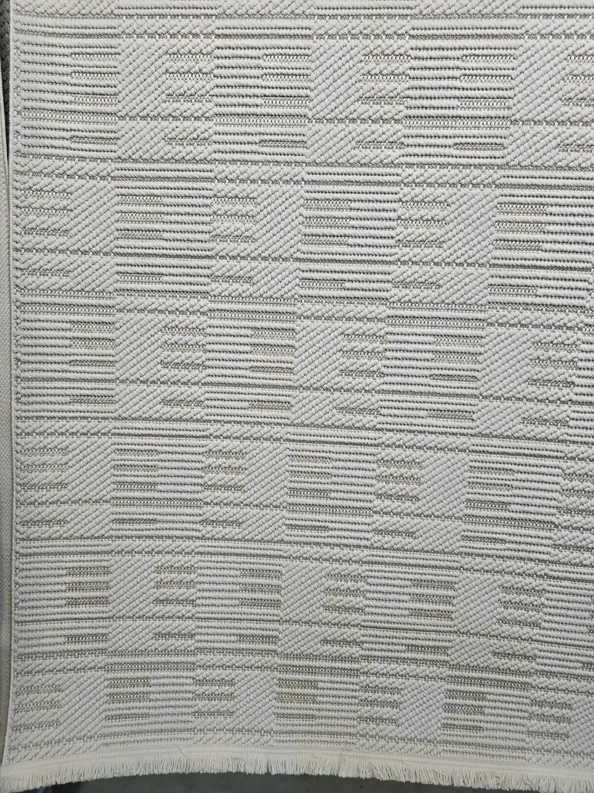 Bottom view of the Vortex rug showing fringe and pattern detail