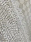 Underside view showing Helios rug fringes and backing details