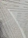 Back view of the Vortex rug with edge binding and fringe visible
