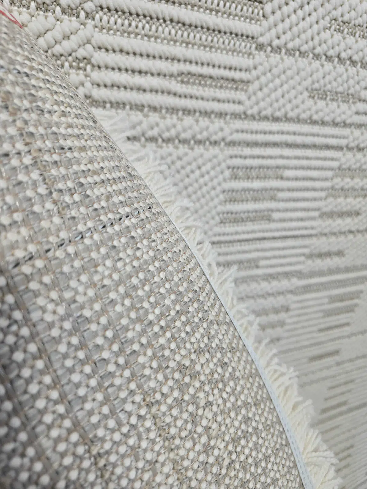Back view of the Vortex rug with edge binding and fringe visible